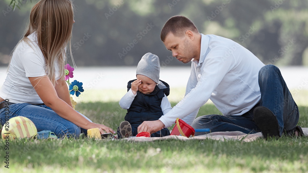 father comforting his crying son for a walk on a summer day father comforting his crying son for a walk on a summer day