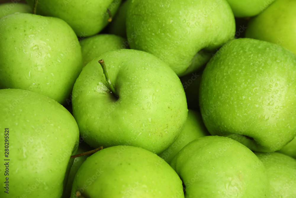 Fresh ripe green apples with water drops as background, closeup view Fresh ripe green apples with water drops as background, closeup view
