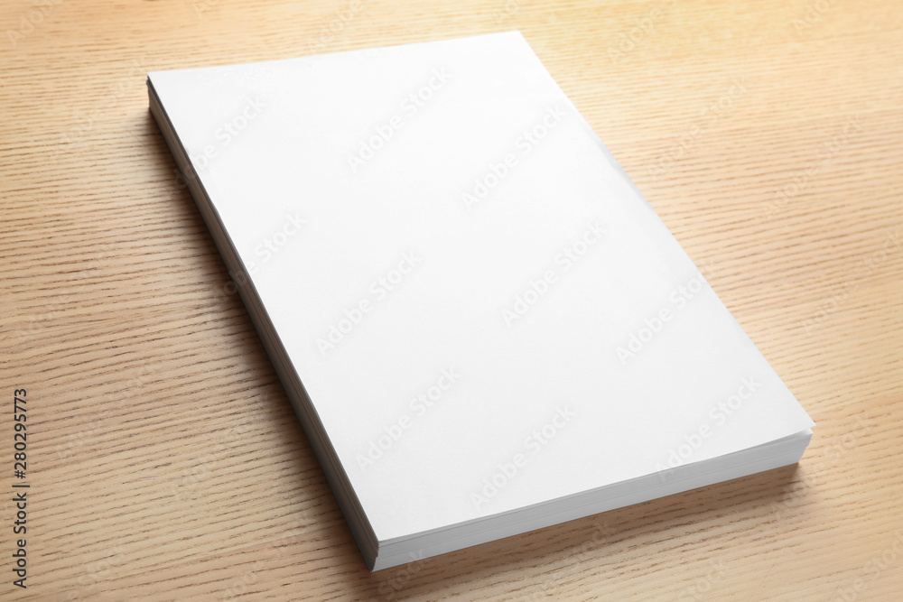 Stack of blank paper sheets for brochure on wooden background. Mock up Stack of blank paper sheets for brochure on wooden background. Mock up
