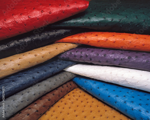 A pile of colourful folded ostrich leather