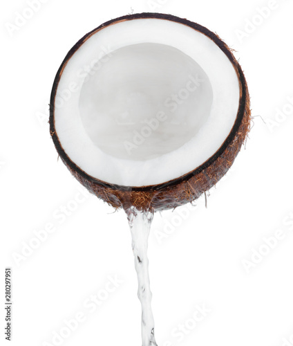 Cracked coconut with splashes of milk on white background