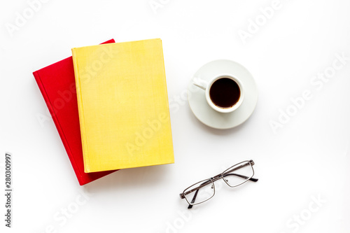 Books with empty cover near glasses, coffee on white desk background top view