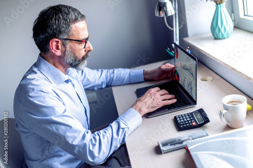 Senior man working on laptop computer