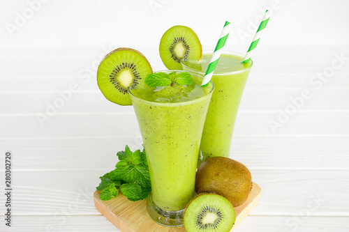 kiwi apple yogurt juice smoothies healthy green beverage taste delicious drink summer have prote colorful in the glass and fruit kiwi yellow on white wood background.