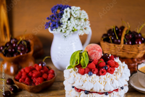 Pavlova meringue cake with cream and berries