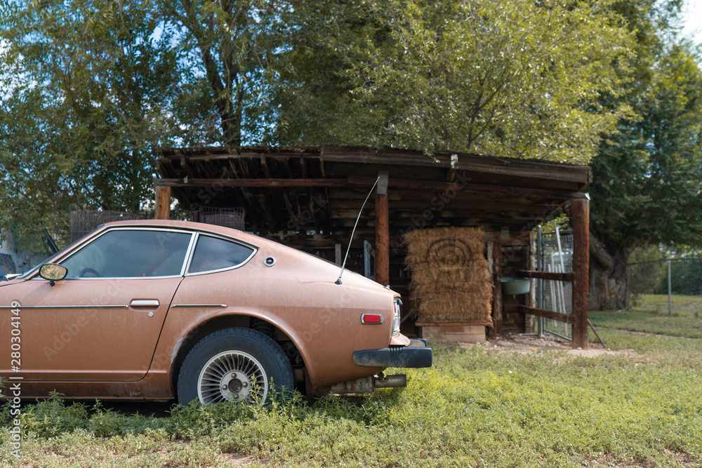 Antique brown car in front of the lean-two in the rural area Antique brown car in front of the lean-two in the rural area
