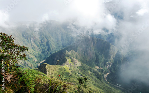 Aerial view of Machu Picchu Inca citadel in the clouds, located on a mountain ridge above the Sacred Valley © nomadkate