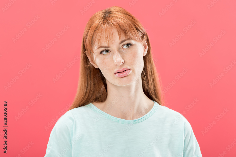 front view of pensive redhead young woman looking away isolated on pink front view of pensive redhead young woman looking away isolated on pink