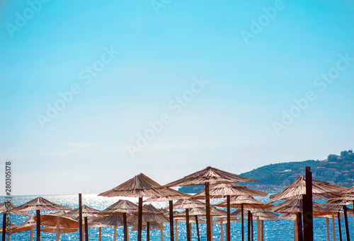 Fototapeta Naklejka Na Ścianę i Meble -  umbrellas on the sunny beach 
