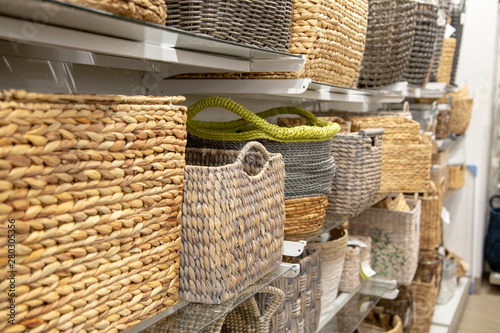 Aisle of hyacinth or rattan weaved baskets inside of home décor store.