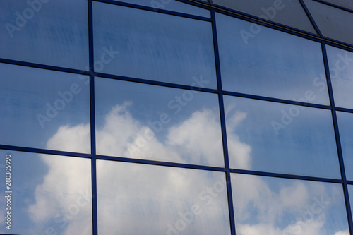 clouds reflected in the window pattern grid skyscraper
