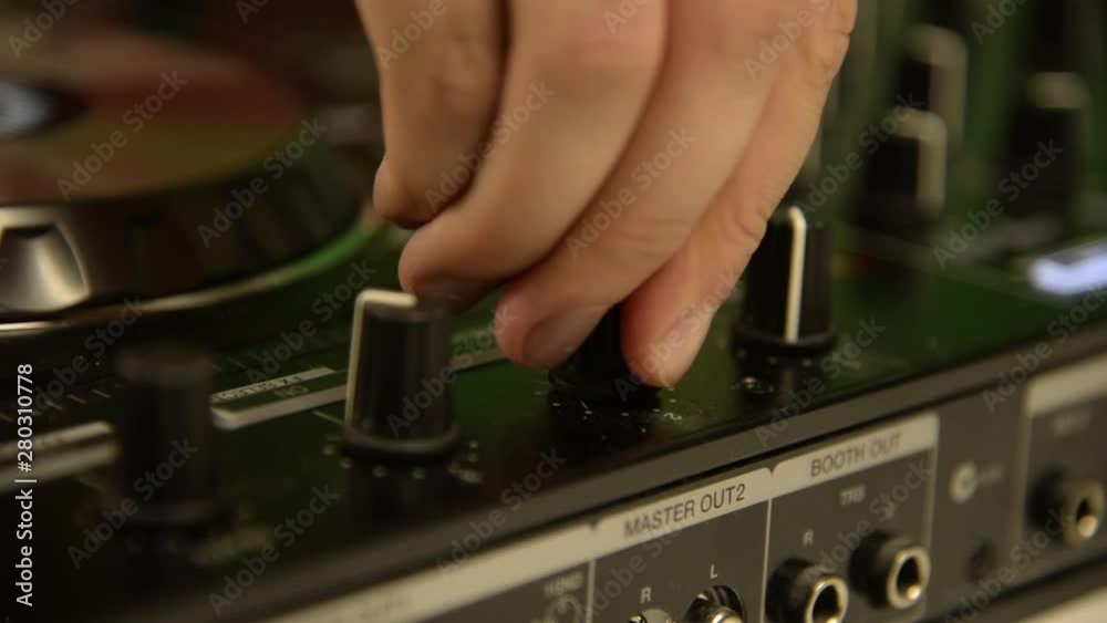DJ playing on music mixer. Black music mixing console. Close up. DJ playing on music mixer. Black music mixing console. Close up.