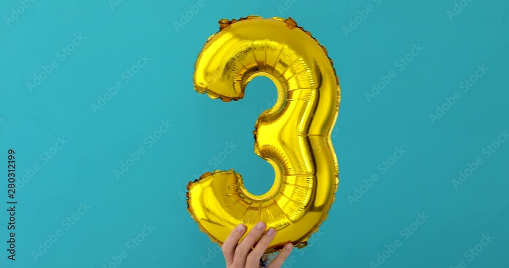 Gold foil number 3 three celebration balloon on blue background