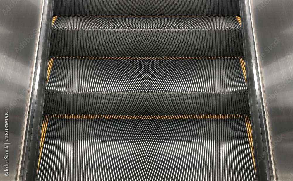 Empty escalator stair machine indoor background.