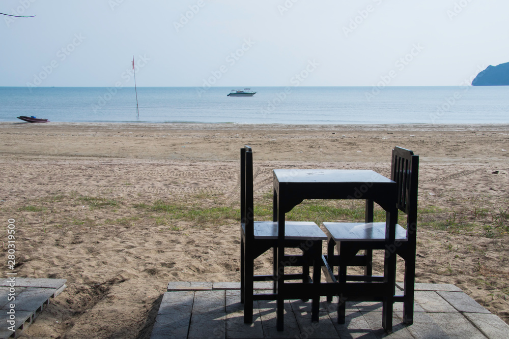 Sea view with chair on the beach and fishing background with beautiful blue sky in sunny day Sea view with chair on the beach and fishing background with beautiful blue sky in sunny day