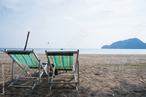 Sea view with chair on the beach and fishing background with beautiful blue sky in sunny day