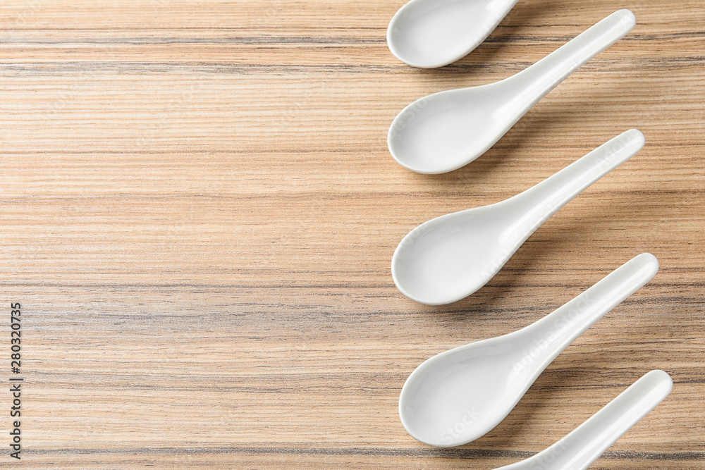 Miso soup spoons on wooden table, flat lay. Space for text Miso soup spoons on wooden table, flat lay. Space for text