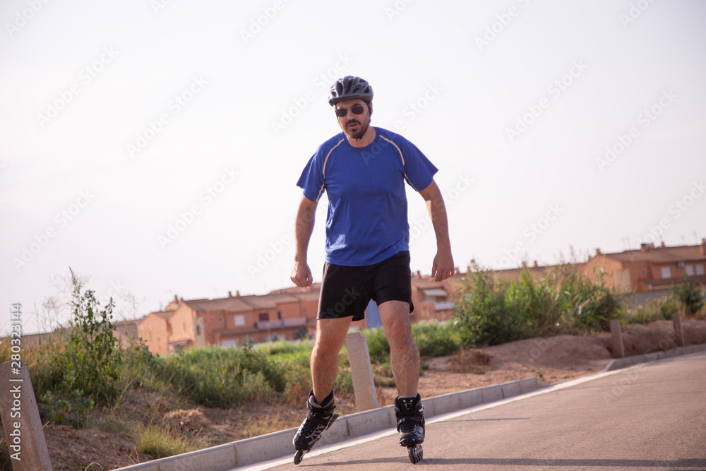 Fototapeta premium man with inline skates skating on the street
