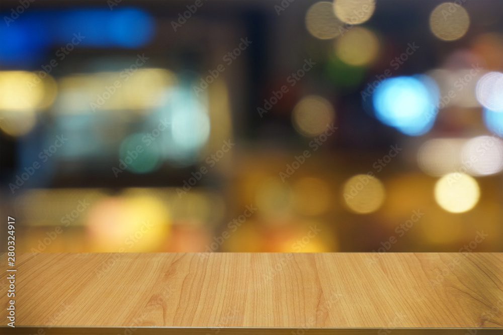 Empty dark wooden table in front of abstract blurred bokeh background of restaurant . can be used for display or montage your products.Mock up for space.