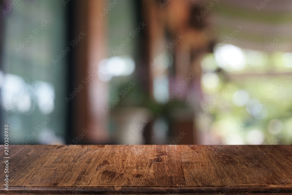 Empty dark wooden table in front of abstract blurred bokeh background of restaurant . can be used for display or montage your products.Mock up for space.