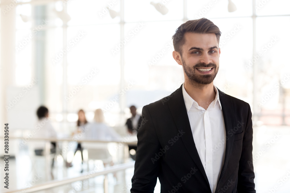 Head shot portrait of successful businessman in office hallway Head shot portrait of successful businessman in office hallway