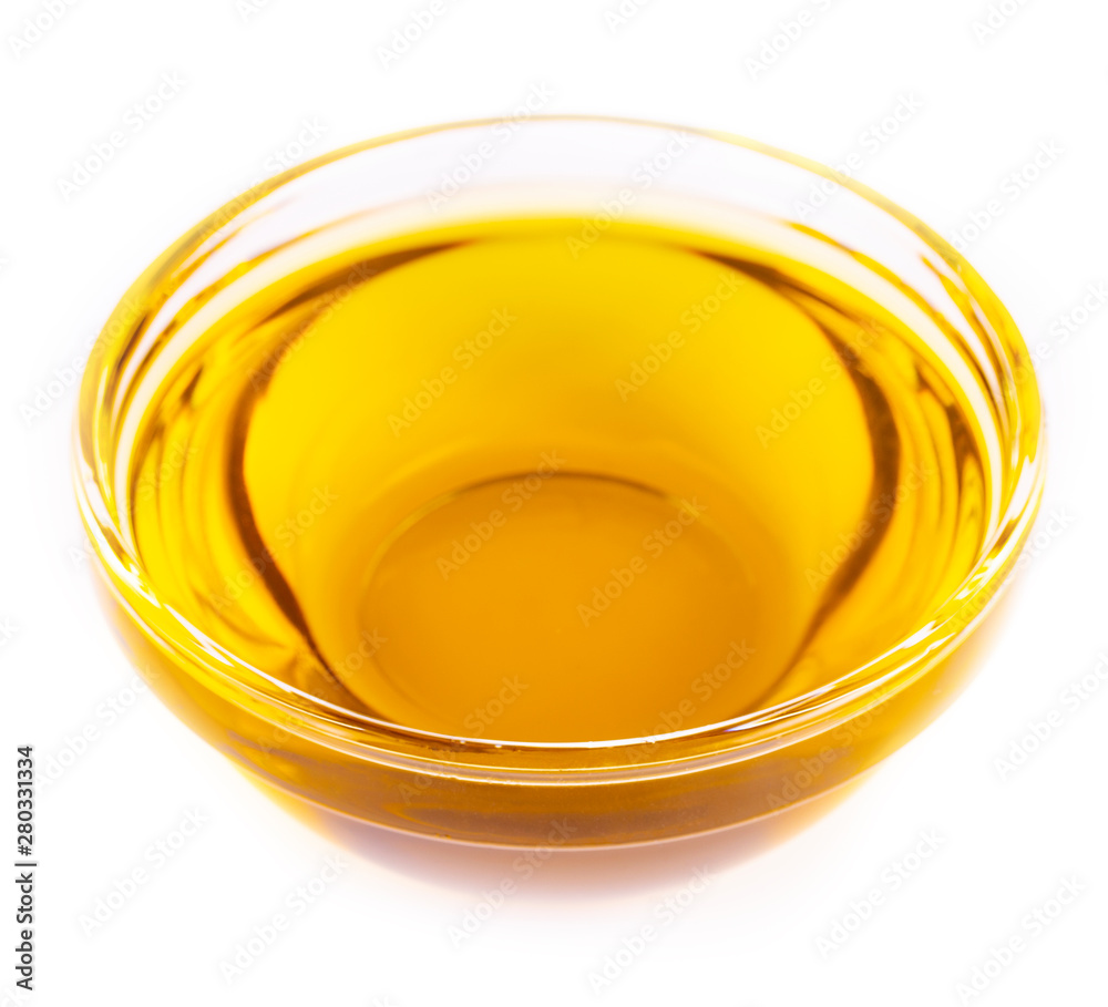 The Pouring cooking oil a small glass cup isolated on white background The Pouring cooking oil a small glass cup isolated on white background