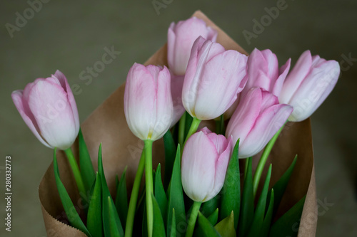 close up of pink tulips in brown paper