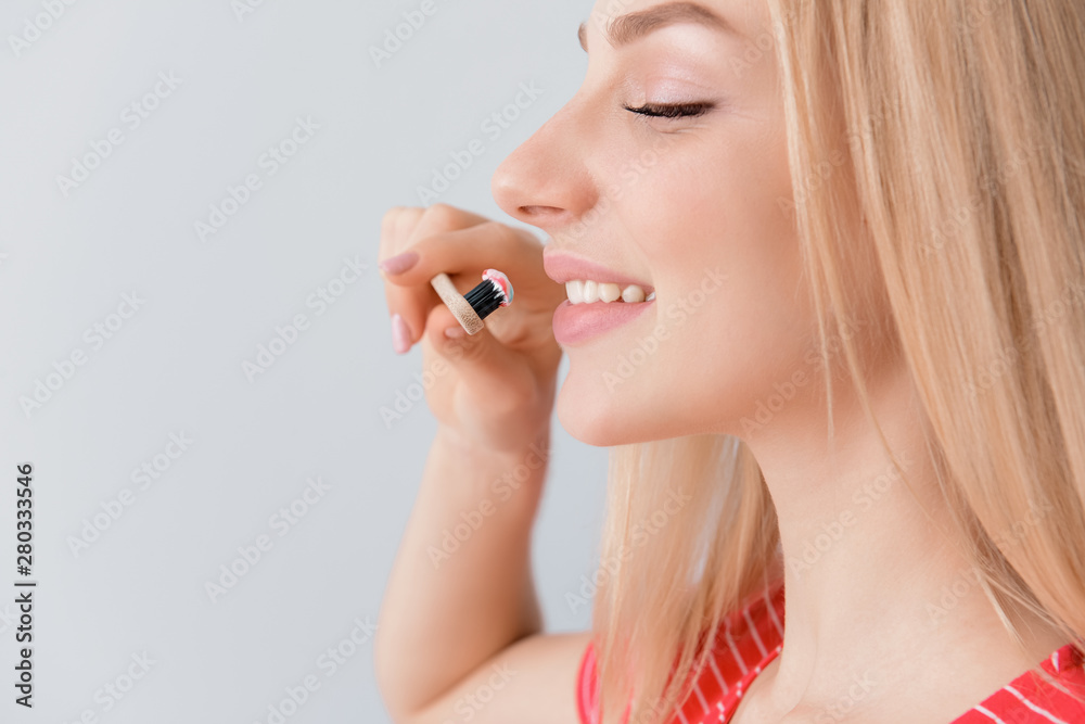 Woman with toothbrush on light background. Concept of dental hygiene Woman with toothbrush on light background. Concept of dental hygiene