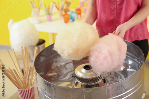 Woman making cotton candy at fair photo