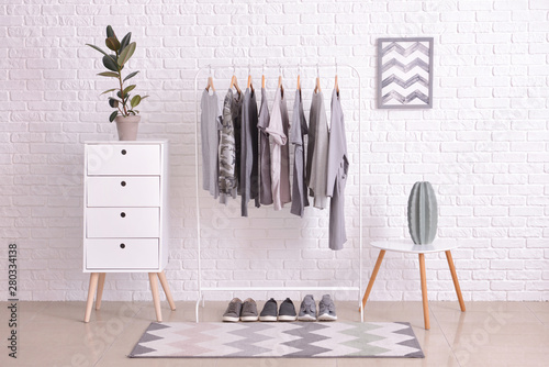 Rack with hanging clothes i...