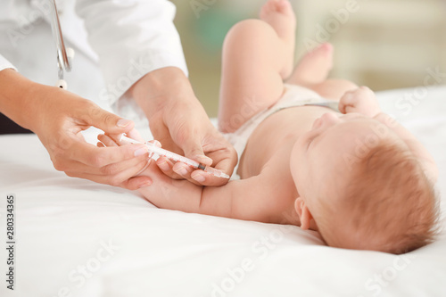 Pediatrician vaccinating little baby in clinic