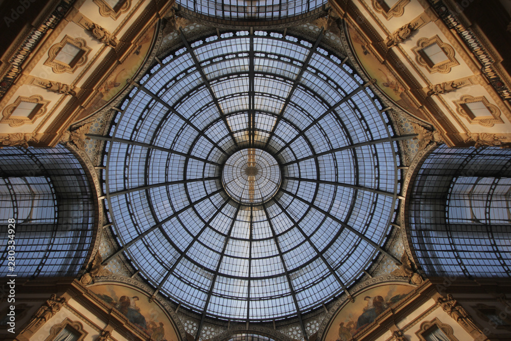 Symmetry sun light roof top above the marvellous interior decoration design of The Galleria Vittorio Emanuele II in Milan, Italy, The oldest shopping mall of Milan.