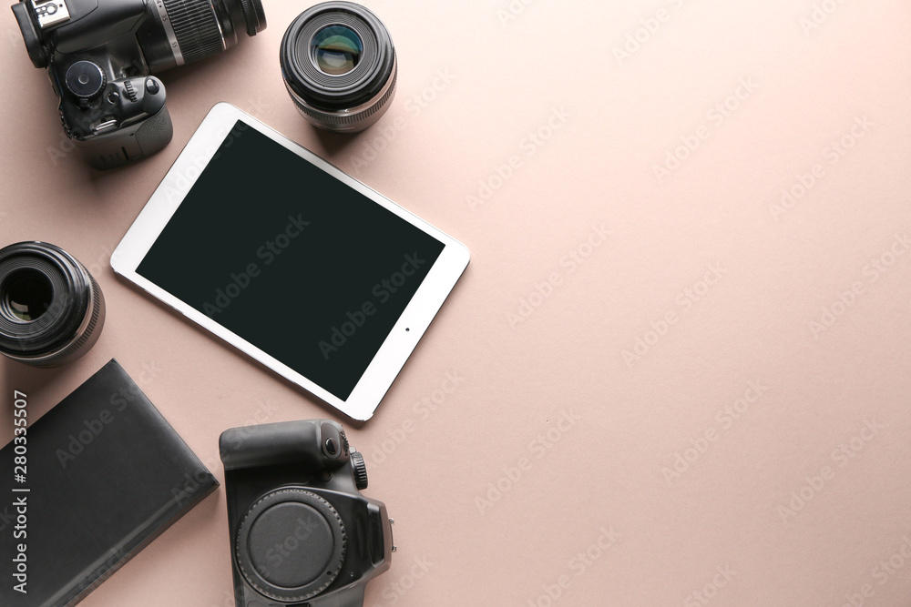 Tablet computer and set of photographer's equipment on color background Tablet computer and set of photographer's equipment on color background