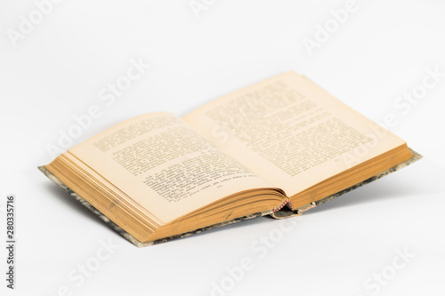 Old open book on white background. Slightly blurred.