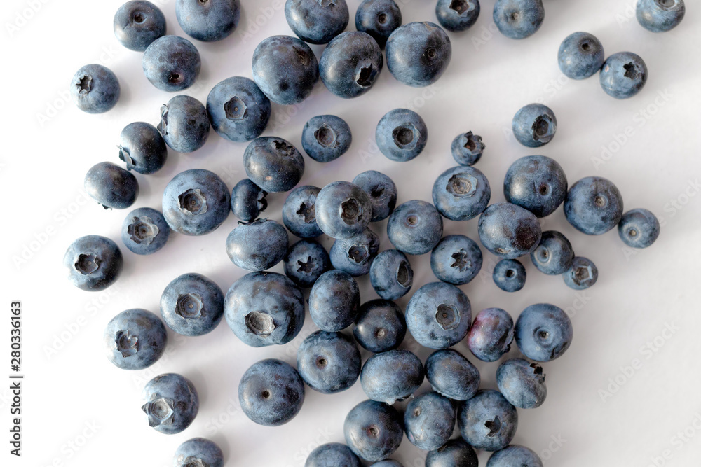 Blueberries scattered on a white table. Blueberries scattered on a white table.