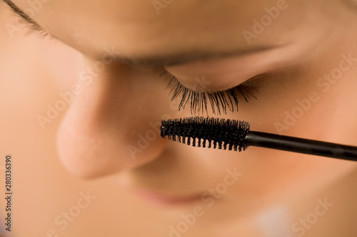 closeup of woman applyinh mascara on her eyelashes