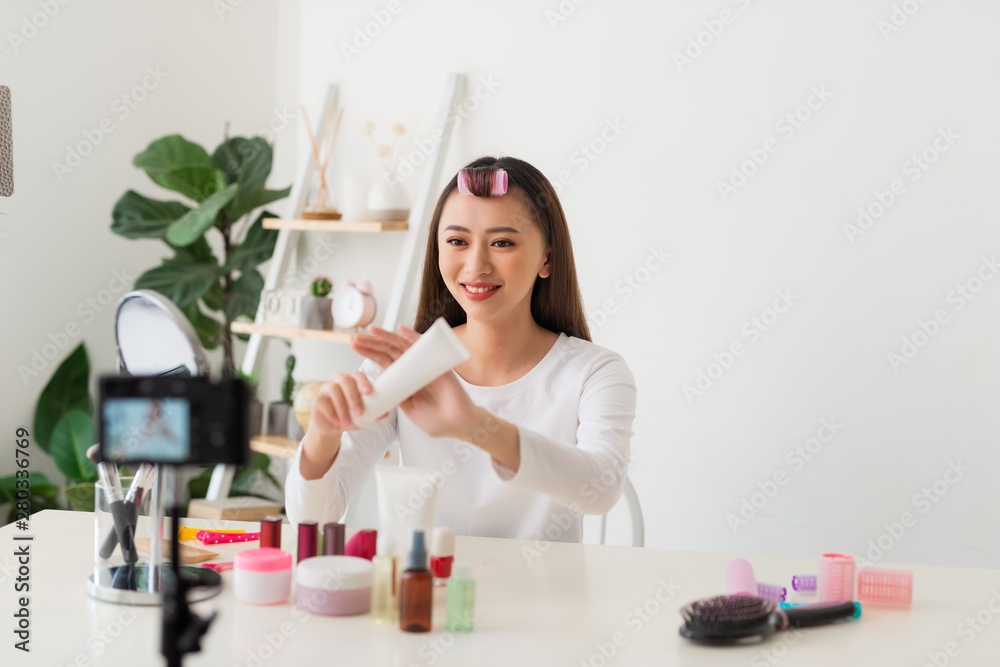 Young woman professional beauty vlogger or blogger recording cosmetic makeup tutorial with camera to share on social media Young woman professional beauty vlogger or blogger recording cosmetic makeup tutorial with camera to share on social media