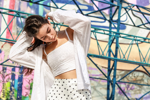 Young beautiful lady wearing a stylish white top.Portrait shooting of a stylish girl.Trends summer 2019. photo