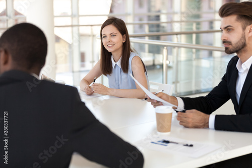 Interested employees sitting at briefing, listen to colleague
