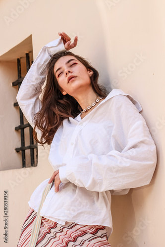 Young beautiful lady wearing a stylish white shirt.Portrait shooting of a stylish girl.Trends summer 2019. photo