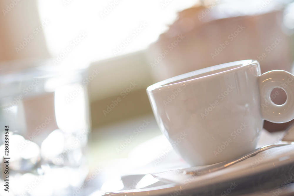 A cup of coffee on a white table in a coffee house