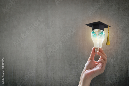 Innovative learning, creative educational study concept for graduation and school student success with world lightbulb on teacher chalkboard photo