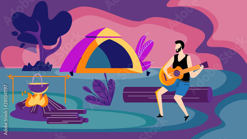 Man Sitting at Campfire at Night Playing Guitar.