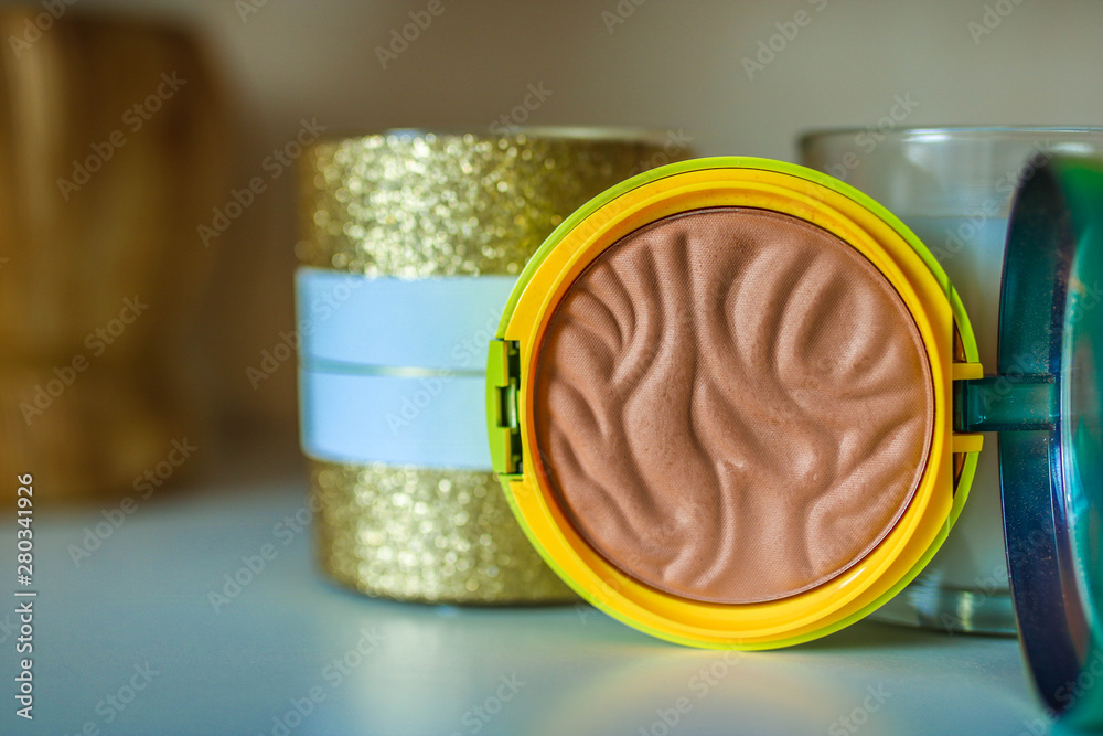 Decorative cosmetics, open compact make up bronxer case, beige bronzer. Professional make up concept. Decorative cosmetics, open compact make up bronxer case, beige bronzer. Professional make up concept.