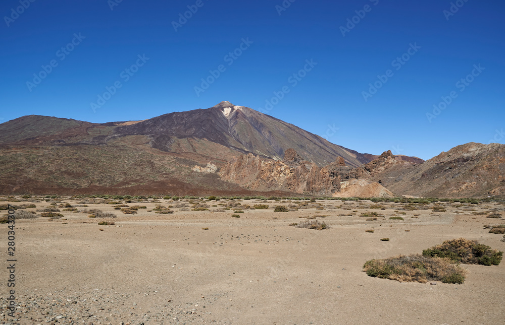 Mount Teide in Tenerife, rising up from the surrounding Desert floor, filled with sand and debris from previous Lava flows and eruptions.