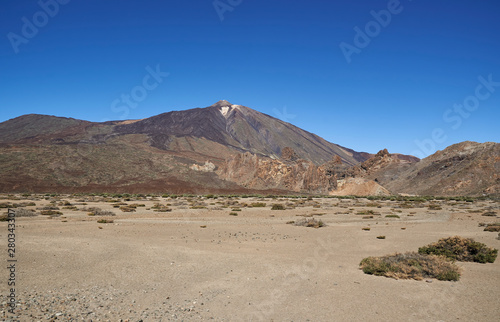 Mount Teide in Tenerife  rising up from the surrounding Desert floor  filled with sand and debris from previous Lava flows and eruptions.