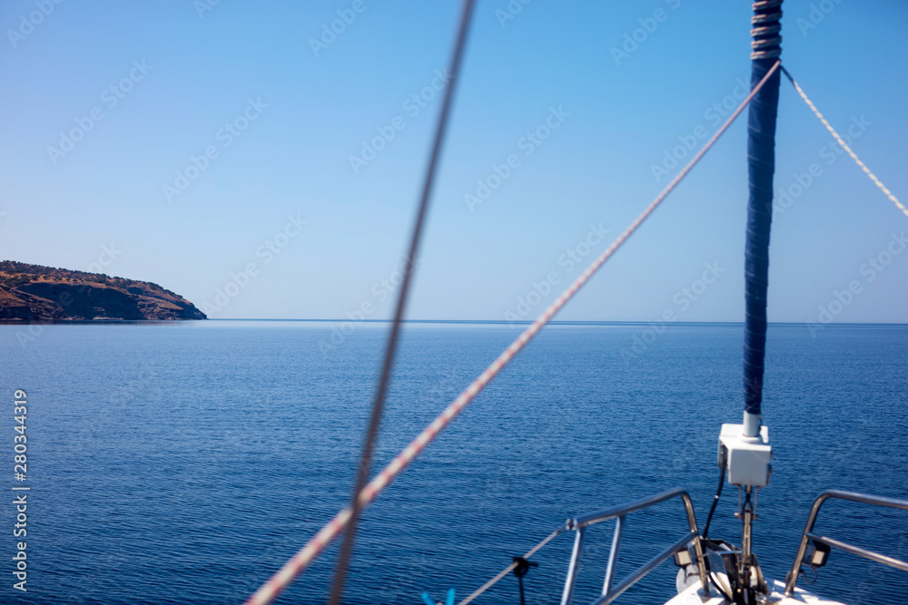 View of a sailing ship front deck and open sea.