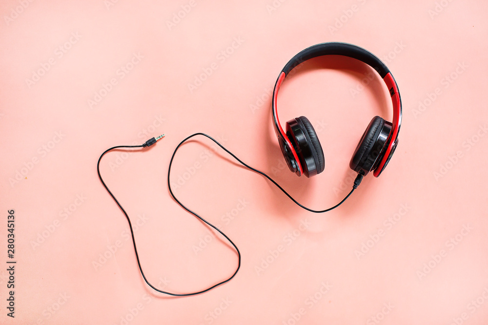 Headphones on pink background with free text space. Music concept. Headphones on pink background with free text space. Music concept.