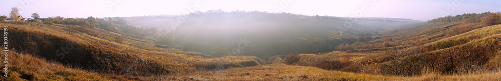 Panoramic view of autumn meadow at sunset