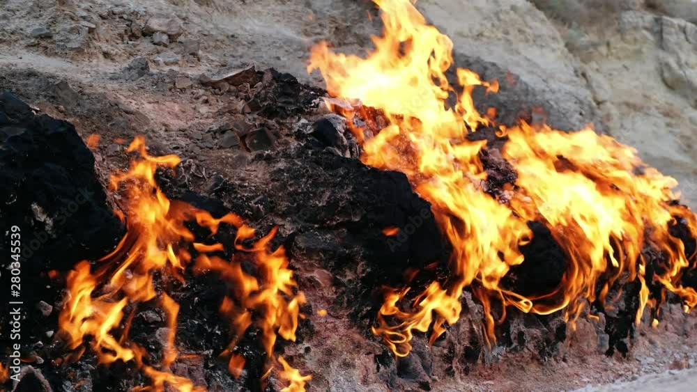Flame of Yanar Dag (burning mountain). Natural gas is burning on the base of hill. Azerbaijan. Flame of Yanar Dag (burning mountain). Natural gas is burning on the base of hill. Azerbaijan.